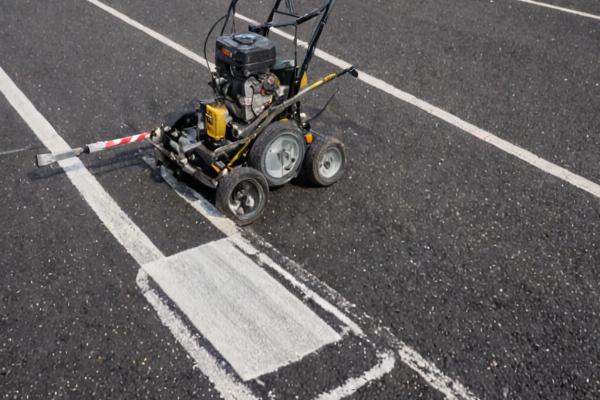 Professional line striping equipment creating precise parking lot markings
