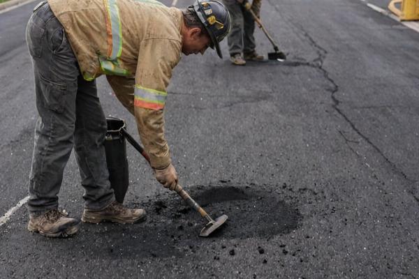 Professional sealcoating application on asphalt surface